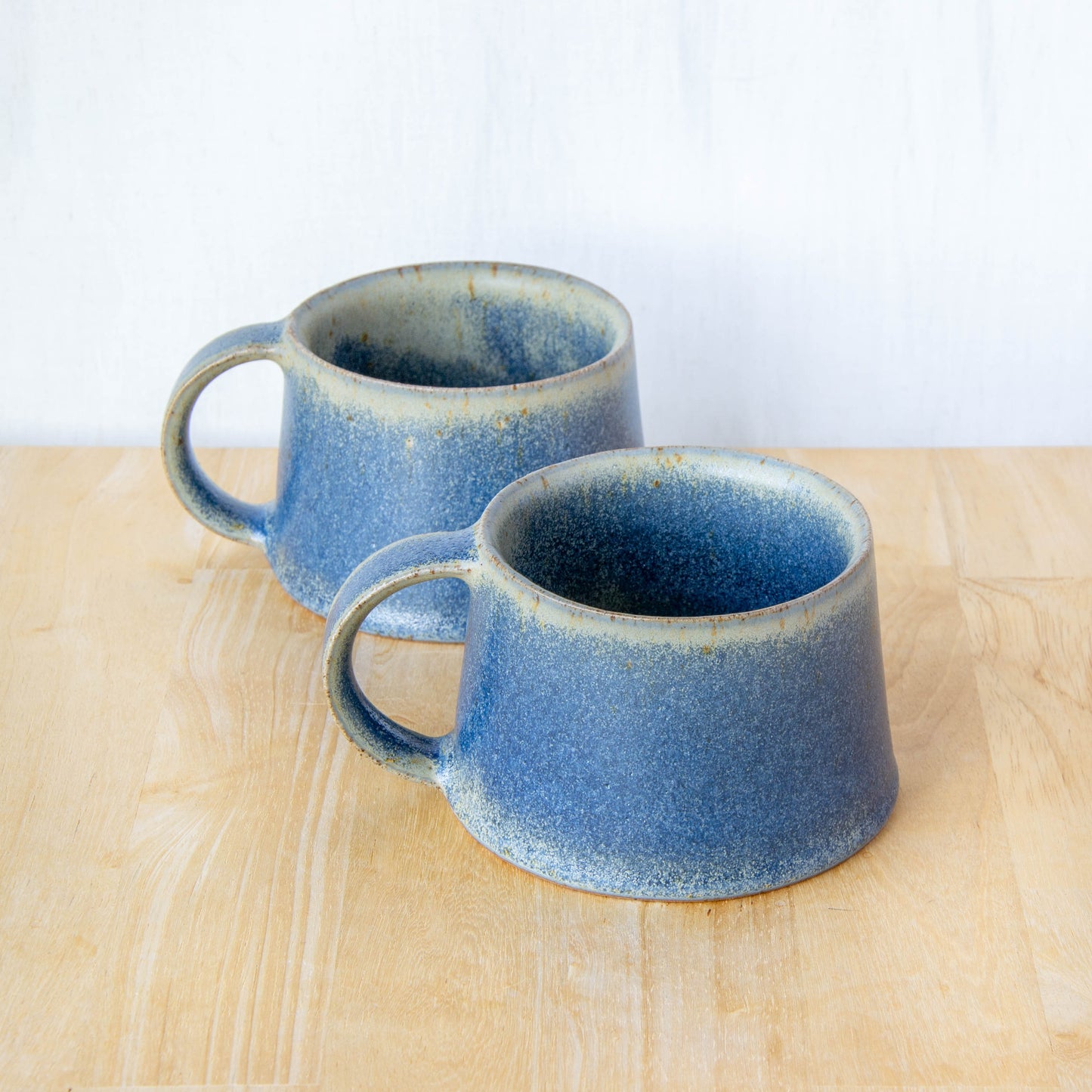 Handmade mug by Land and Line Ceramics New Zealand made pottery blue mug. tapered mug with rustic wabi-sabi style glaze
