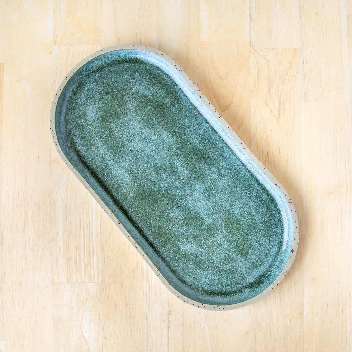 rounded oblong pill shaped plate handmade cheese board platter rustic green glaze