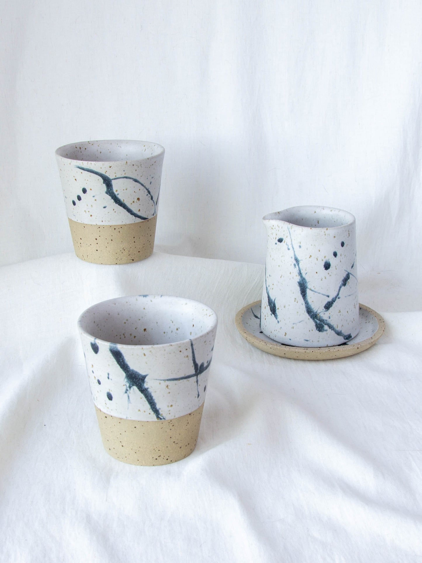 Ceramic milk jug and matching cups. Handmade in Queenstown, New Zealand by Land and Line Ceramics. Modern rustic design with a wabi sabi, japandi style