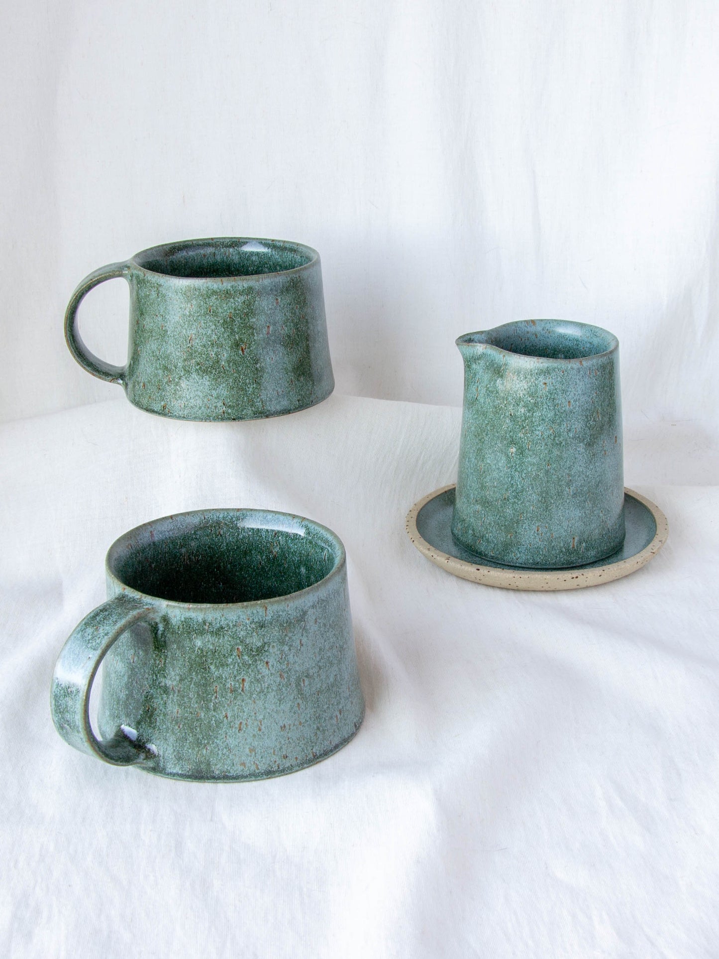 Ceramic milk jug and matching cups. Handmade in Queenstown, New Zealand by Land and Line Ceramics. Modern rustic design with a wabi sabi, japandi style