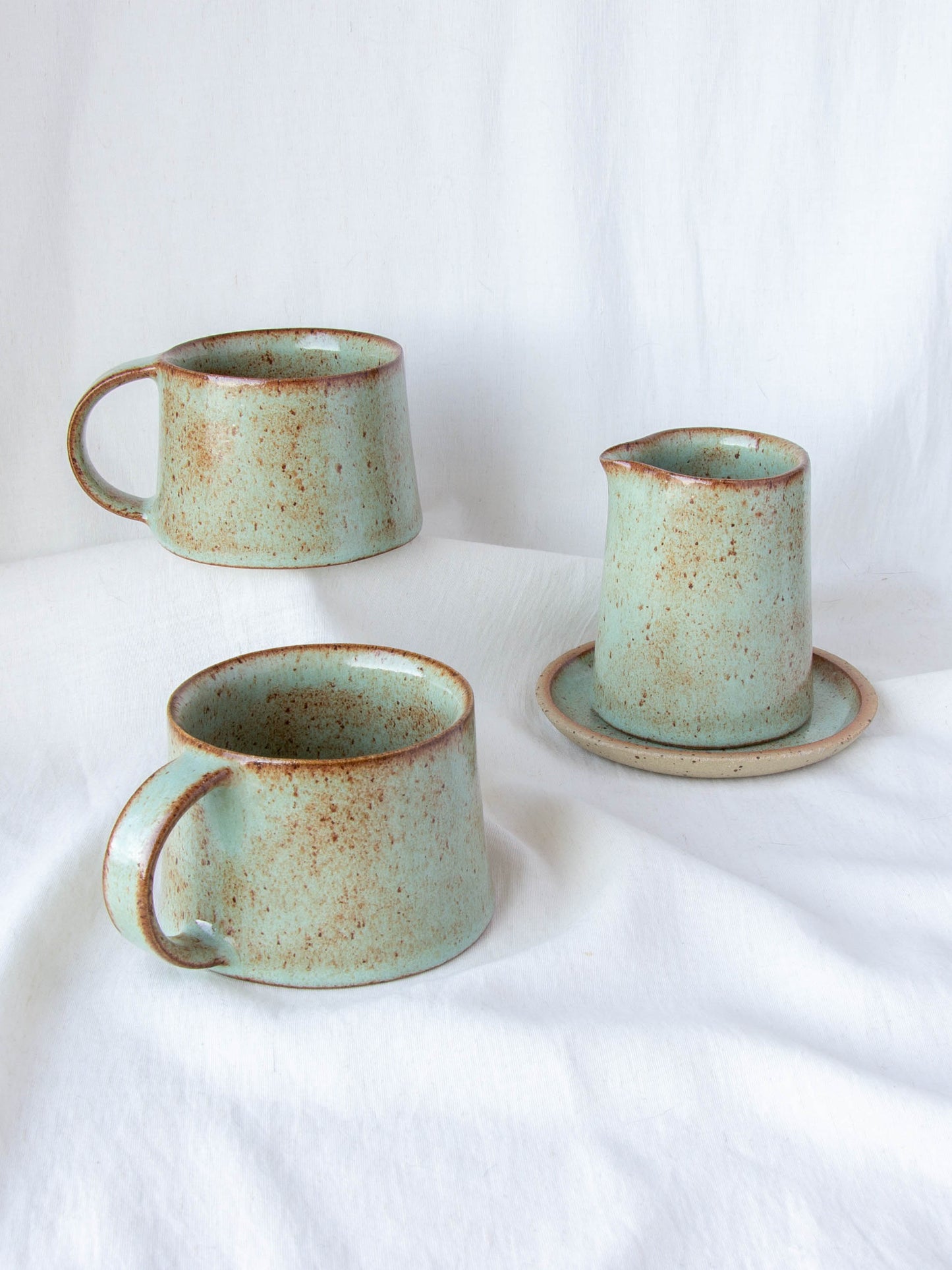 Ceramic milk jug and matching cups. Handmade in Queenstown, New Zealand by Land and Line Ceramics. Modern rustic design with a wabi sabi, japandi style