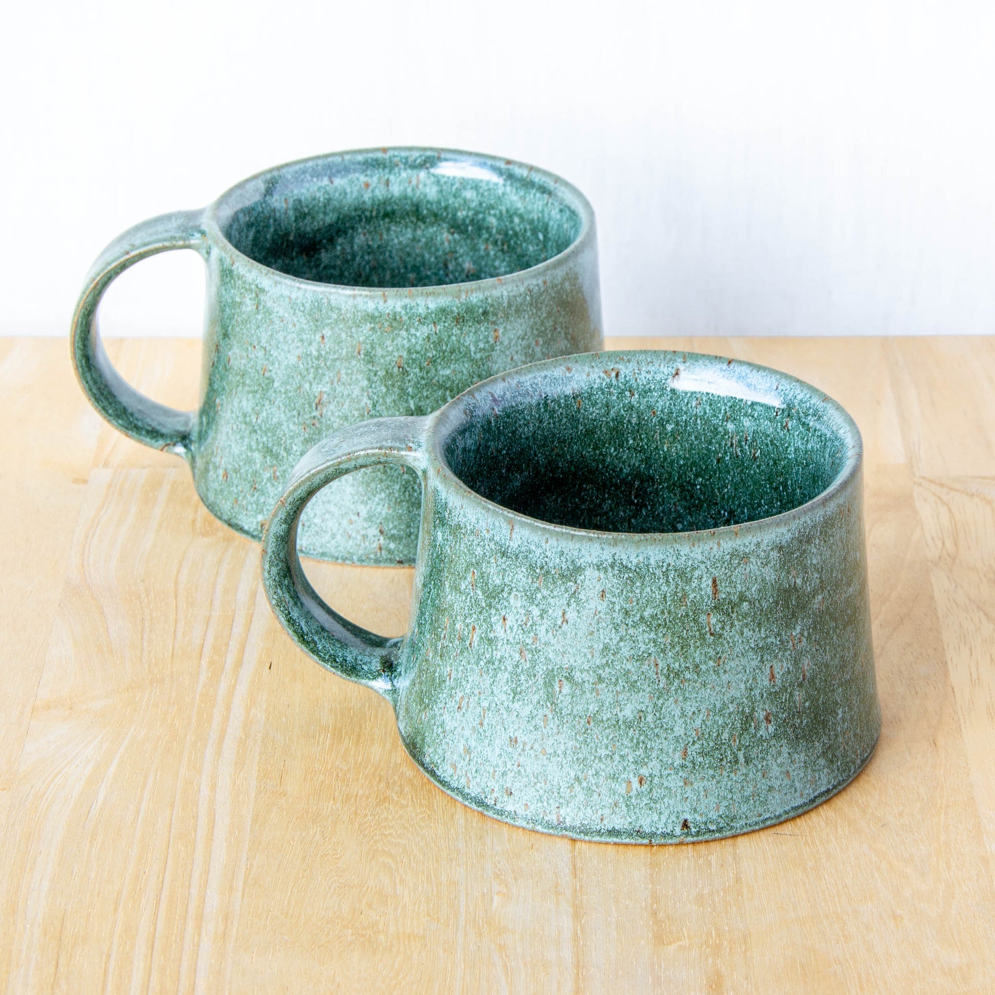 Handmade mug by Land and Line Ceramics New Zealand made pottery greenstone mug. tapered mug with rustic wabi-sabi style glaze