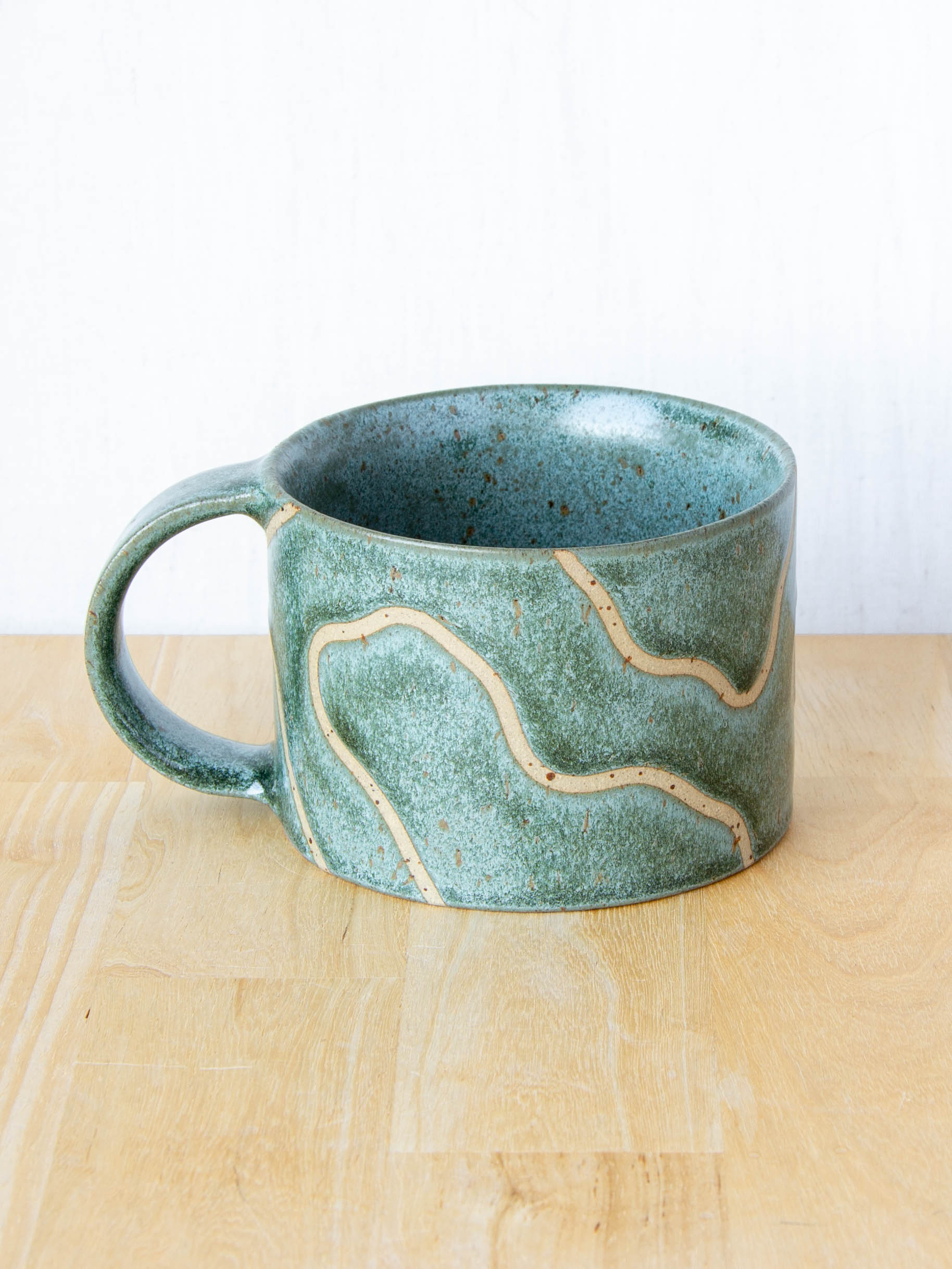 handmade ceramic mug with topographic map design made in New Zealand by Land and Line Ceramics