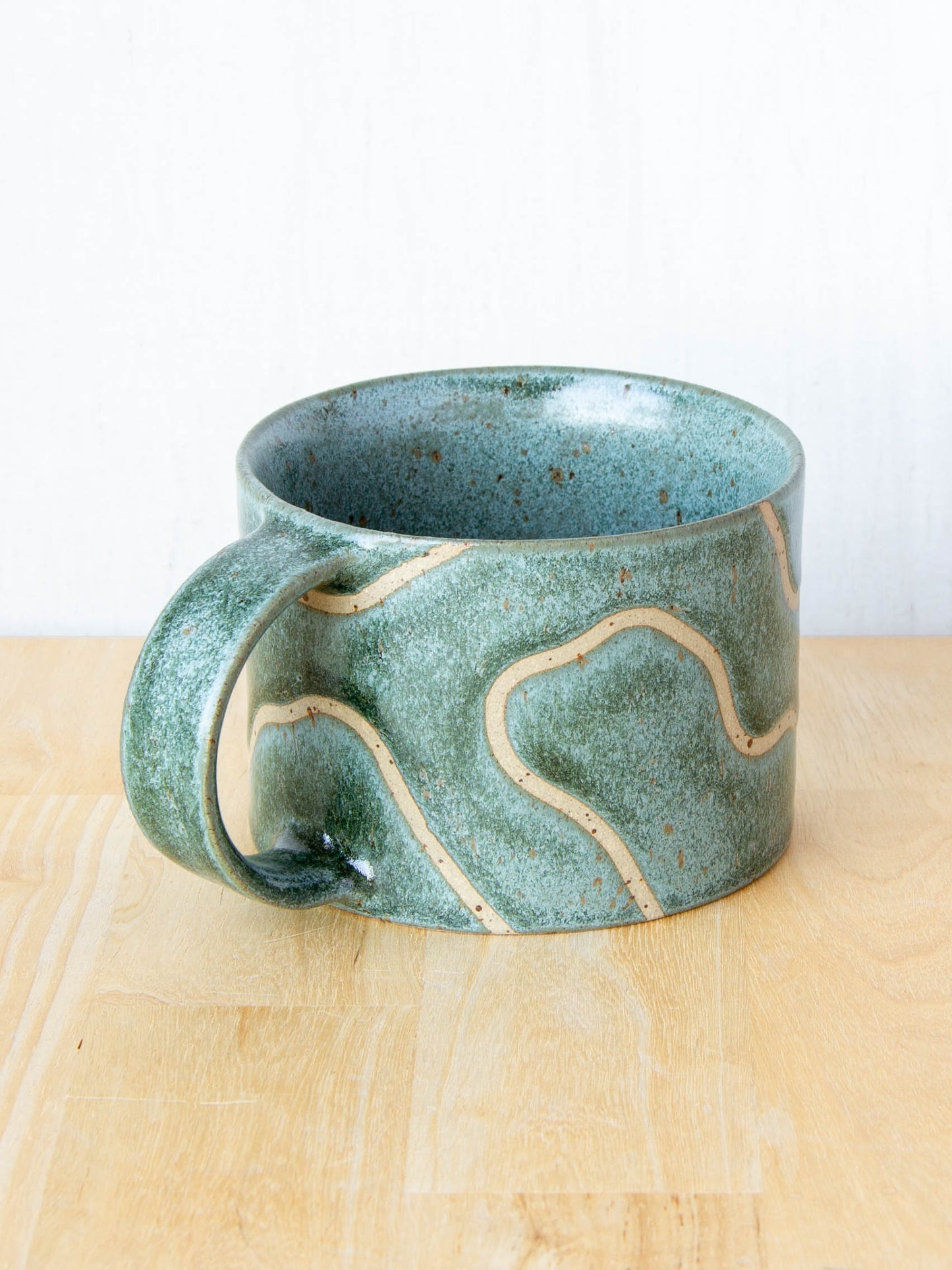 handmade ceramic mug with topographic map design made in New Zealand by Land and Line Ceramics
