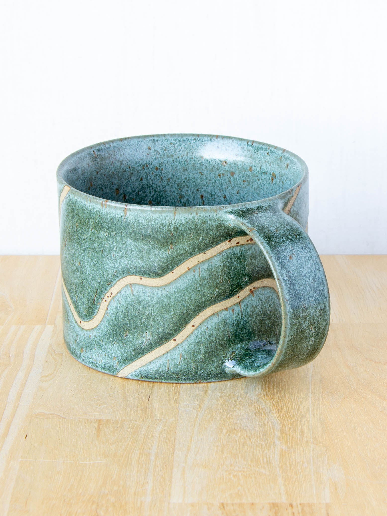 handmade ceramic mug with topographic map design made in New Zealand by Land and Line Ceramics