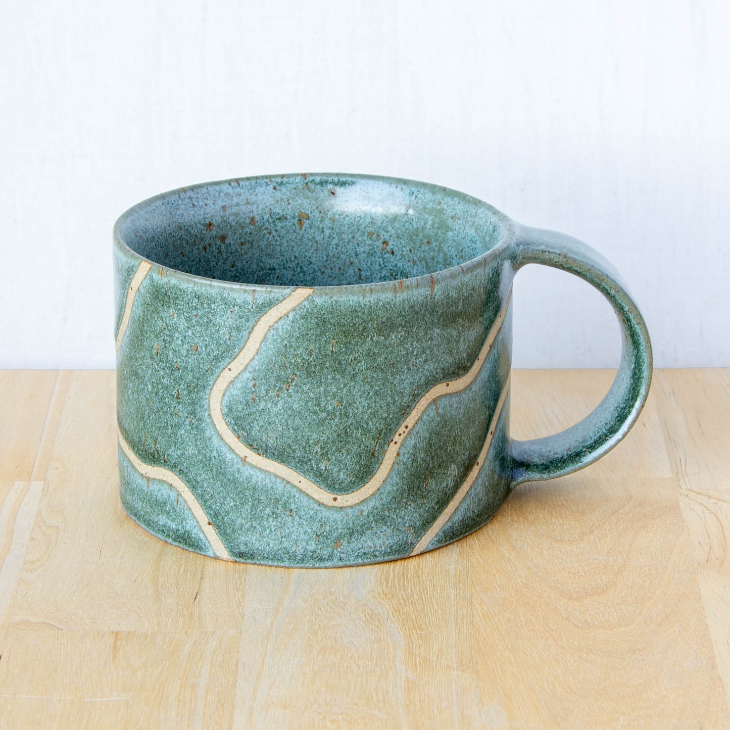 handmade ceramic mug with topographic map design made in New Zealand by Land and Line Ceramics