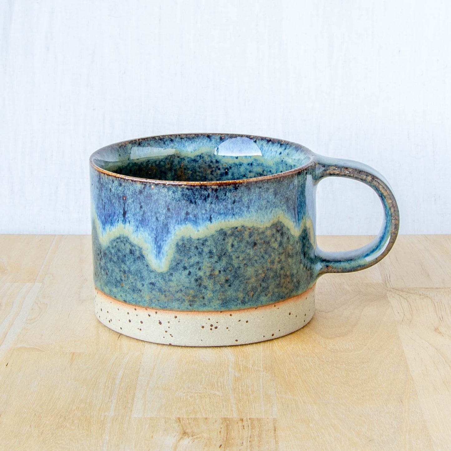 blue mug with abstract landscape and speckled clay made in New Zealand