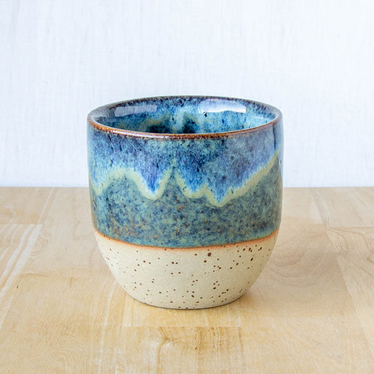 Blue coffee mug tumbler handmade with abstract landscape and speckled clay by land and line ceramics