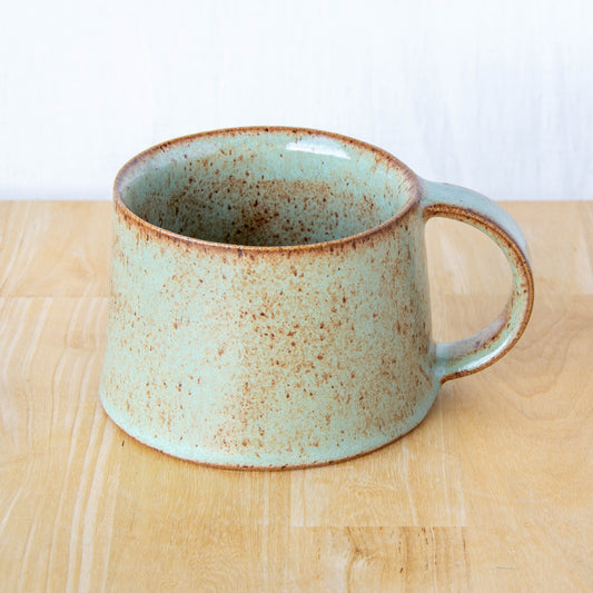 Handmade mug by Land and Line Ceramics New Zealand made pottery green mug tapered mug with rustic wabi-sabi style glaze