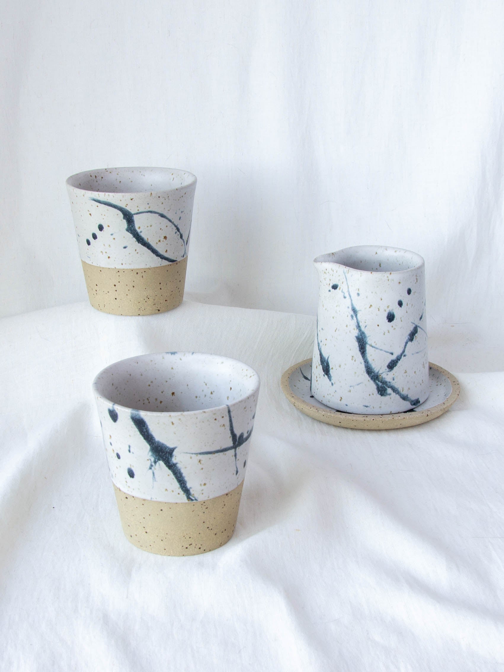 Ceramic milk jug and matching cups. Handmade in Queenstown, New Zealand by Land and Line Ceramics. Modern rustic design with a wabi sabi, japandi style