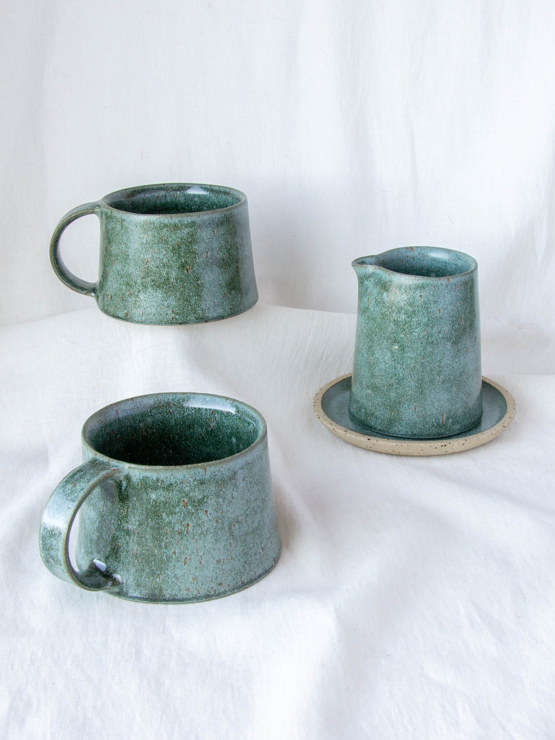 Ceramic milk jug and matching cups. Handmade in Queenstown, New Zealand by Land and Line Ceramics. Modern rustic design with a wabi sabi, japandi style